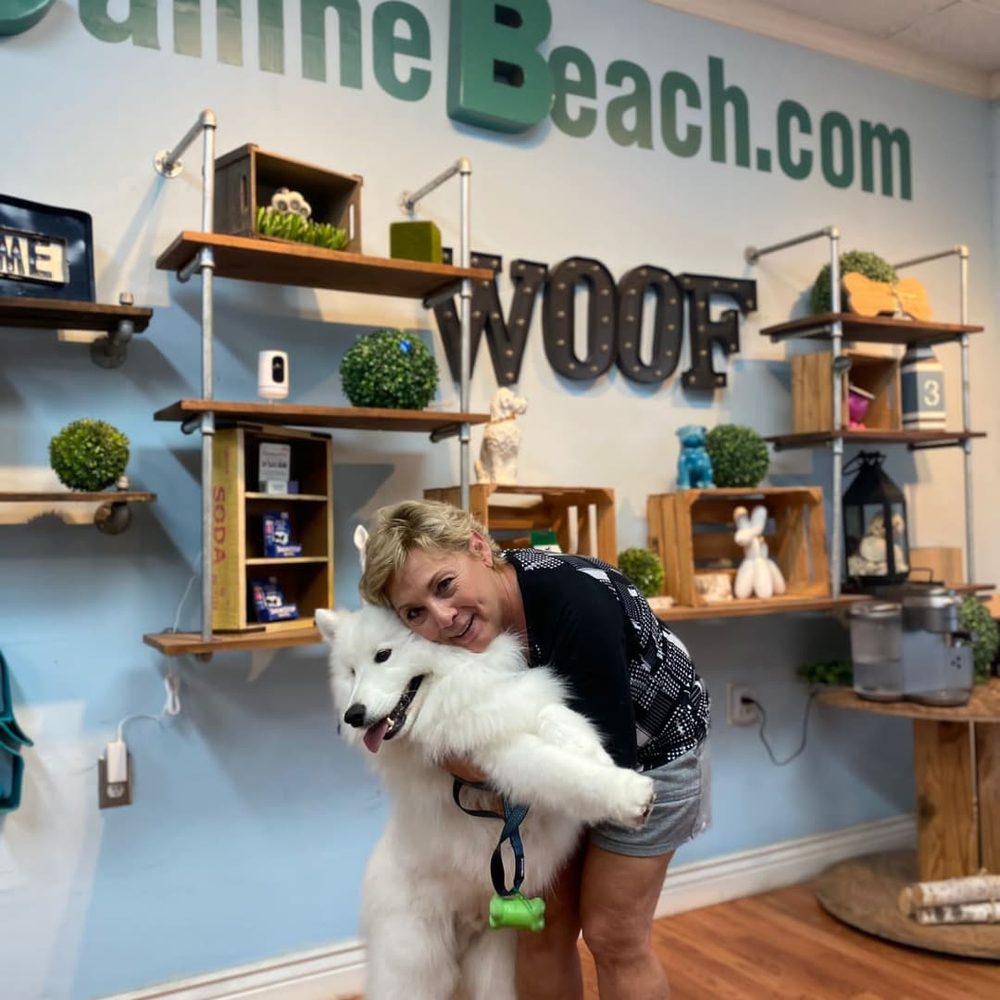 Owner Gio with a freshly groomed Samoyed at Canine Beach Pet Grooming